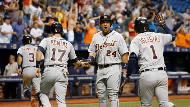 Tigers first baseman Miguel Cabrera (24) congratulates second baseman Ian Kinsler (3), third baseman Andrew Romine (17) and shortstop Jose Iglesias (1) as they score during the ninth inning of the Tigers' 10-7 win Thursday.