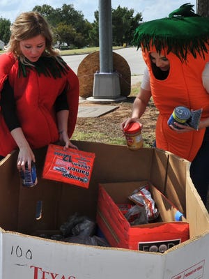 In this file photo, Wichita Falls Area Food Bank employees Ashley Holt, left, and Emily Kincaid dressed as vegetables to help promote a recent food drive. An anonymous donor will double your contribution through Aug. 31.