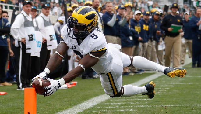 Jabrill Peppers of the Michigan Wolverines dives for a first quarter touchdown while playing the Michigan State Spartans.