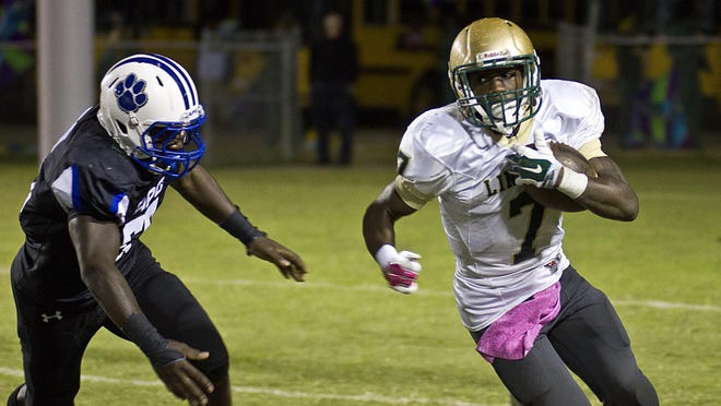 Lincoln running back Ricky Henrilus goes for a gain against Godby during last year’s 22-17 loss to the Cougars.