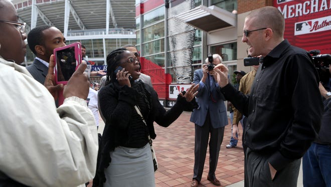 Activists with opposing views yell in disagreement after a press conference outside of Great American Ball Park. Local clergy and Hamilton County leaders called on Major League Baseball to speak out on racial justice as the All-Star Game comes to Ohio.