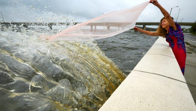 Marie Tao, an artist from Tampa, came out to the waterfront at Tampa Bay to see what the status of the water was Monday morning, a day after the bay's waters receded as Hurricane Irma came ashore.