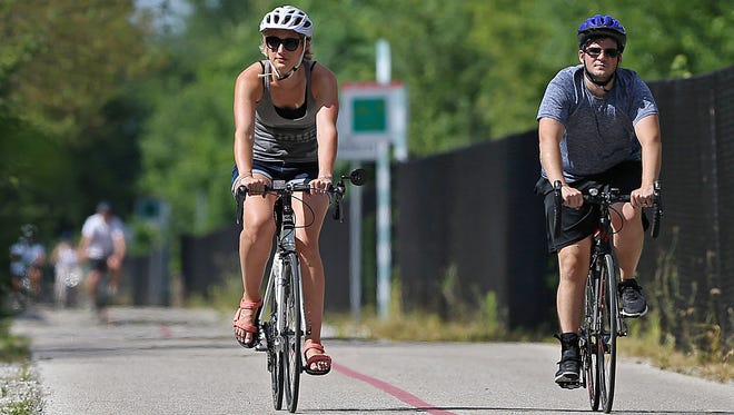 Two cyclists brave the heat along the Monon Trail approaching 16th Street, Indianapolis, Saturday, July 30, 2016.