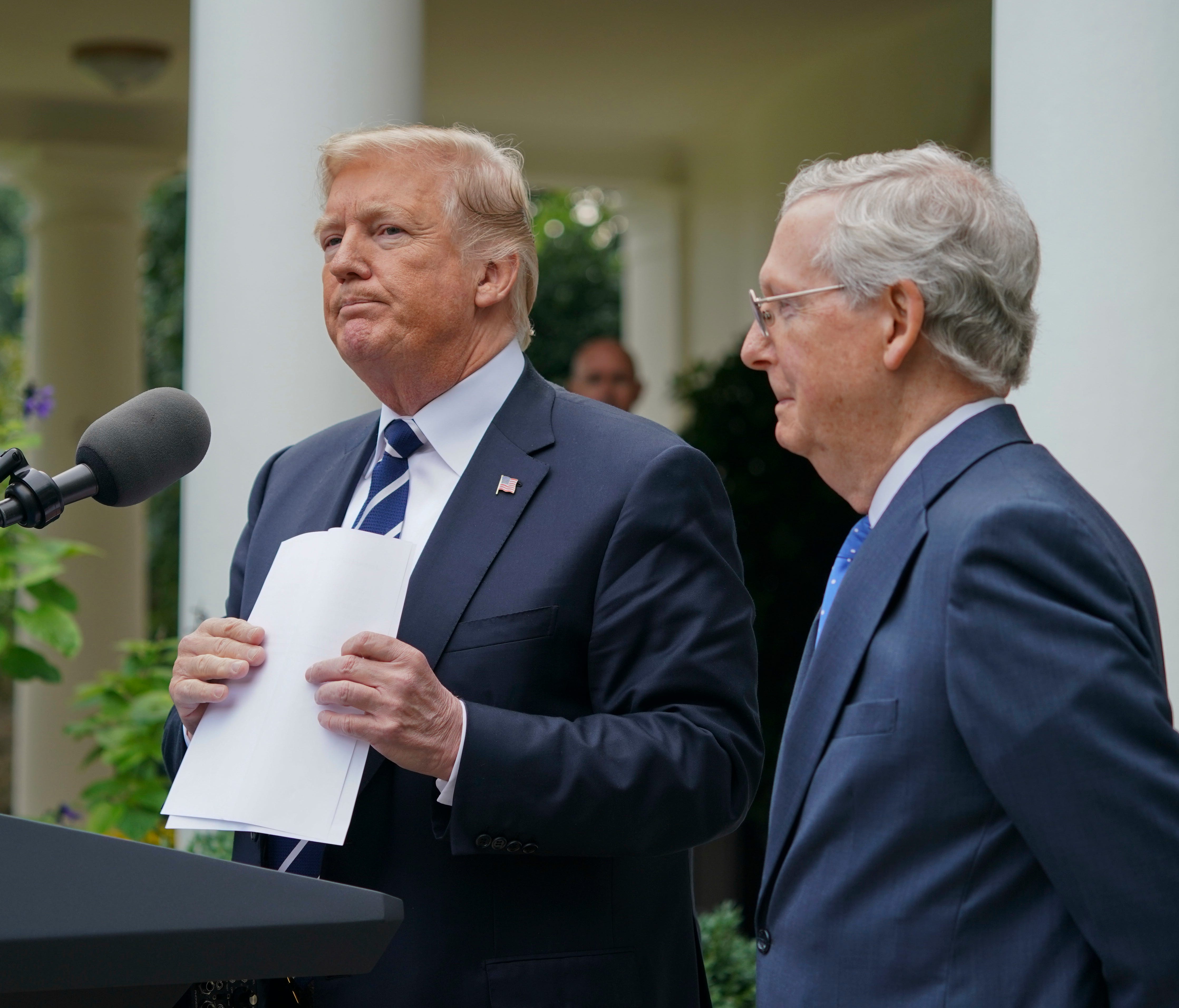 President Trump picks up his notes after he and Senate Majority Leader Mitch McConnell finish up speaking to members of the media in the Rose Garden on Oct. 16, 2017.