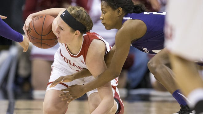 Amanda Cahill (left), of Indiana, gathers a loose ball against Christen Inman of Northwestern, Big Ten Women's Basketball Tournament, Bankers Life Fieldhouse, Indianapolis, Friday, March 4, 2016. Northwestern won 79-73.