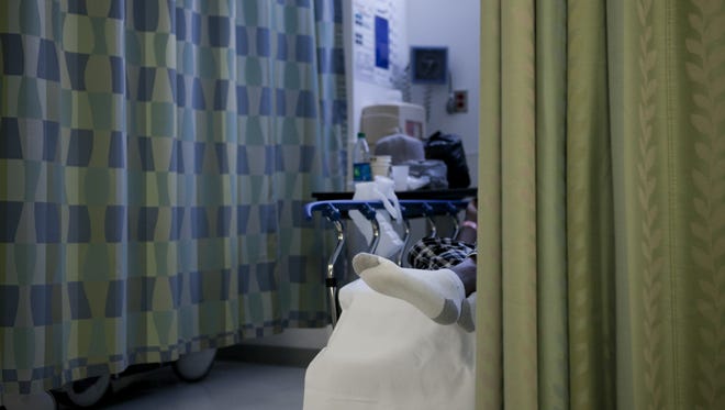 A patient waits in the emergency room of Cooper University Hospital in Camden.