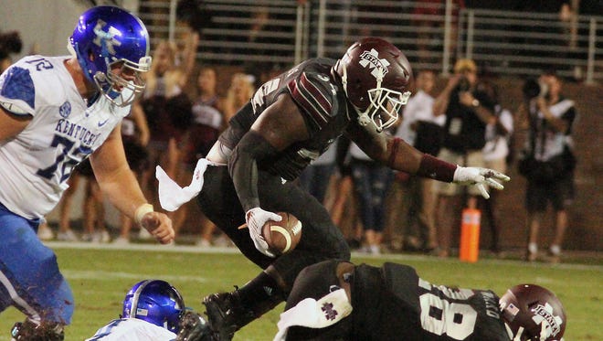 Mississippi State defensive lineman Cory Thomas (34) intercepts a pass ahead of Kentucky center Jon Toth (72) as Mississippi State teammate DeAndre Ward (28) attempts to keep his balance during the second half of an NCAA college football game in Starkville, Miss., Saturday, Oct. 24, 2015. Mississippi State won 42-16. (AP Photo/Jim Lytle)