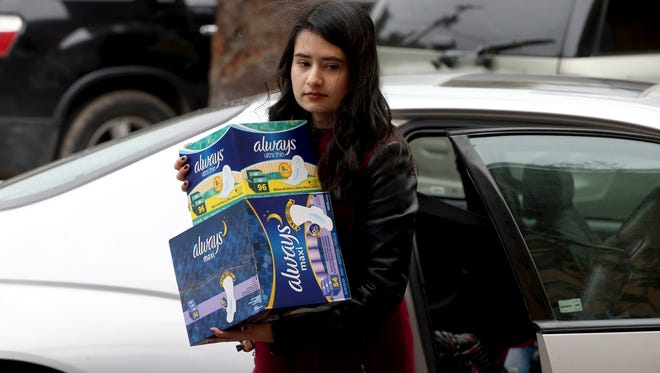Ashley Arevalo delivers pads and tampons to the Women's Shelter and Mother Theresa Shelter on Thursday, Dec. 8, 2016, in Corpus Christi.