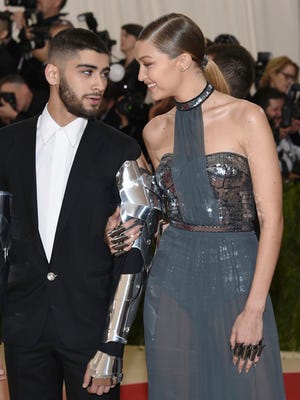FILE - In this May 2, 2016, file photo, Zayn Malik, left, and Gigi Hadid arrive at The Metropolitan Museum of Art Costume Institute Benefit Gala, celebrating the opening of "Manus x Machina: Fashion in an Age of Technology" in New York. Malik announced on March 8, 2017, that Hadid photographed him for a Versace campaign.