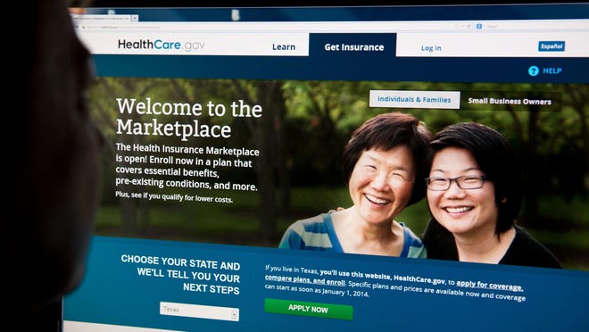 This file photo taken on October 1, 2013 shows a woman looking at the HealthCare.gov insurance exchange internet site in Washington, DC.