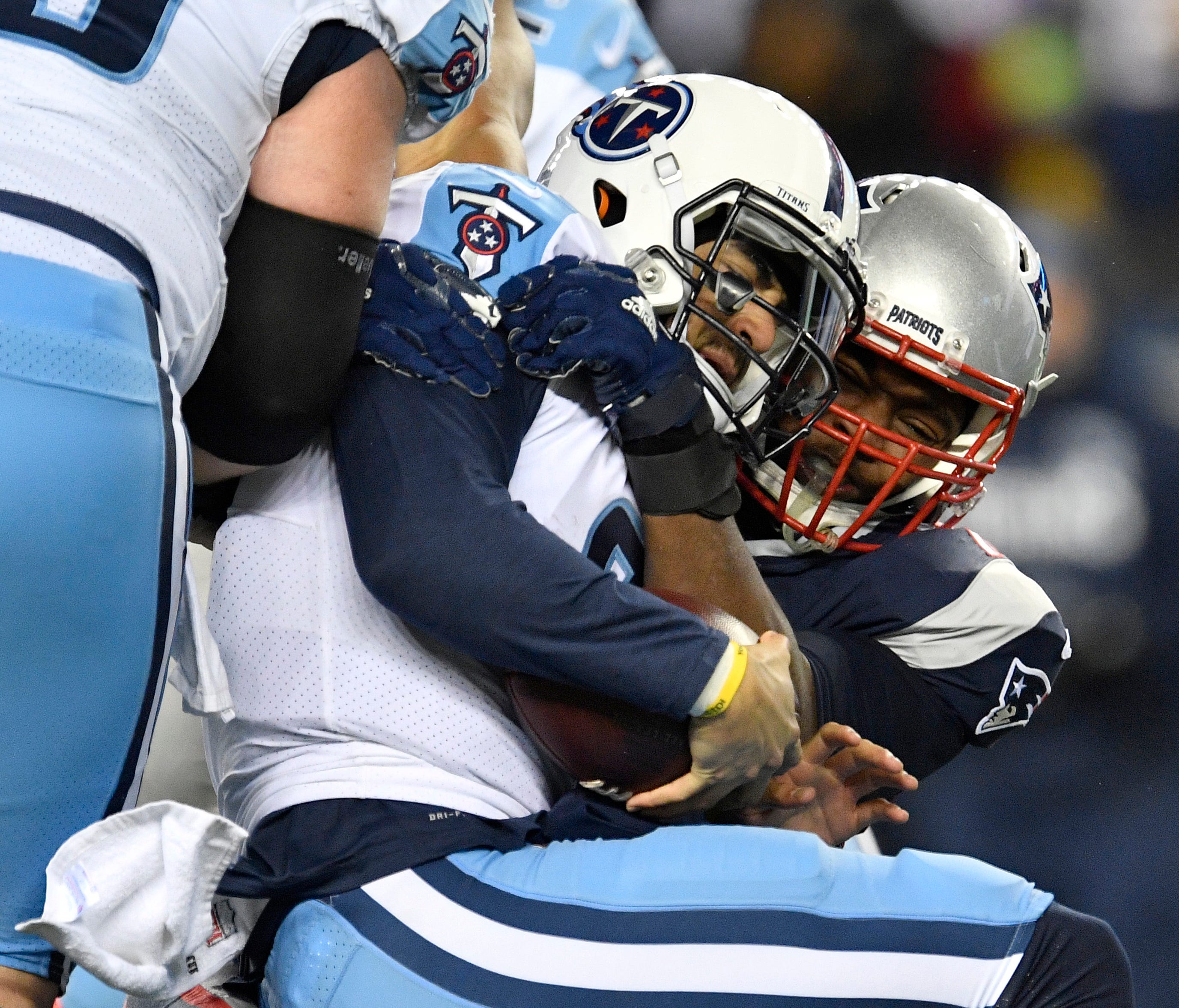Titans quarterback Marcus Mariota (8) is sacked by Patriots defensive tackle Adam Butler (70) during the second half of the AFC Divisional Playoff game at Gillette Stadium Saturday, Jan. 13, 2018, in Foxborough, Mass.