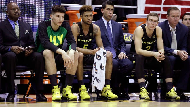 Players and coaches on the Oregon bench, including Tyler Dorsey (5) and Casey Benson (2), watch the game in the second half of an NCAA college basketball game against California Thursday, Feb. 11, 2016, in Berkeley, Calif. California won, 83-63.