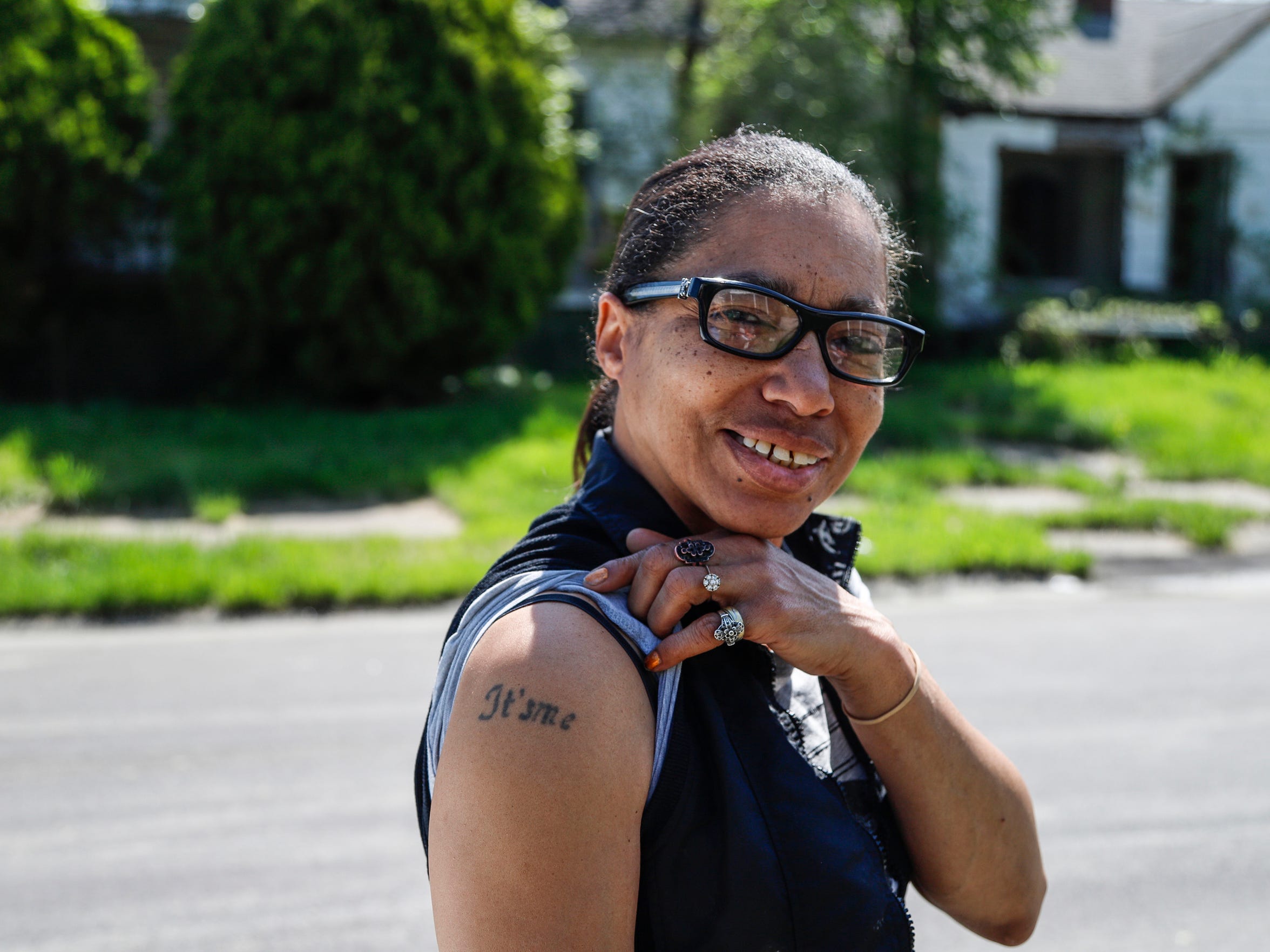 Alpine Street resident Aquin Hill in May shows off a tattoo of her nickname on her right arm. (Photo taken May 17, 2018)