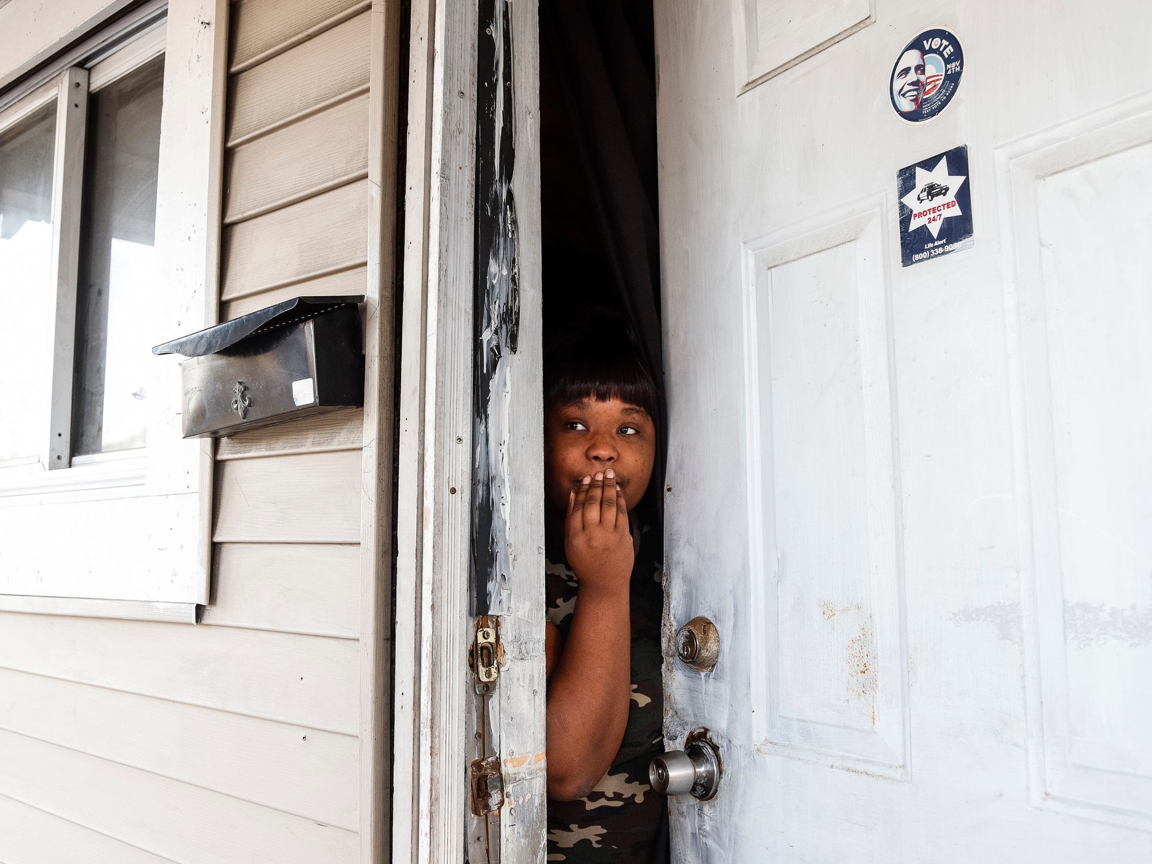 Pauletta Lawrence talks to the Free Press in December from the door of a land bank house on Richton where Immanuel Foster, 7, was found tortured in 2014. The boy died. (Photo taken Dec. 20, 2017)