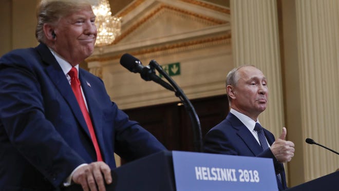 Russian President Vladimir Putin, right, gestures while speaking as U.S. President Donald Trump, left, looks on during their joint news conference at the Presidential Palace in Helsinki, Finland, Monday, July 16, 2018. (AP Photo/Pablo Martinez Monsivais)