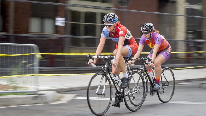 Cyclists bike around downtown Muncie during one of a dozen races on for Muncie Bike Fest in 2016.