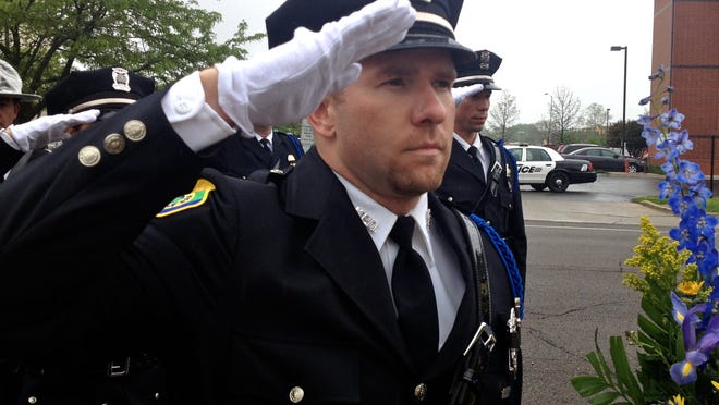 MPD officer Kris Swanson salutes during the 2014 Police Week ceremony, held to honor fallen officers.