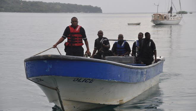 Jamaican Marine Police return to the Port Antonio Marina after a fruitless search for a plane that crashed into the ocean near Port Antonio, Jamaica, on Friday.