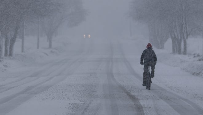 A biker riding north on Johnston Drive in Manitowoc during the snow storm Tuesday, Feb. 2.