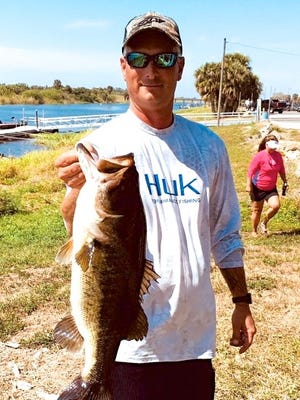 Matt Hinman holds his 7.70-pound bass that helped he and his brother, Gary, win the two-day Space Coast Bass Finatics club tournament on Lake Okeechobee. Their total weight for 10 bass was 35.48 pounds. The club members in 25 boats weighed in 184 bass totaling 400.1 pounds. All but one bass were released alive.