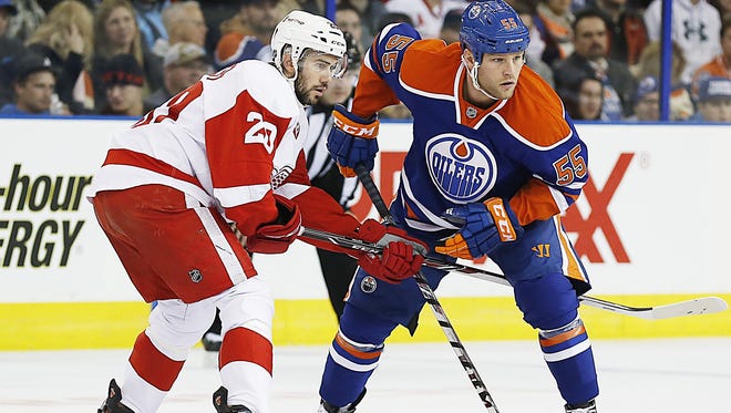 Edmonton Oilers forward Ben Eager, right, and Detroit Red Wings forward Drew Miller battle for position at Rexall Place.