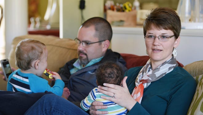 Thomas and Christina Dent relax with their two foster children at their home in Ridgeland on Thursday. The couple already had two children of their own when they became foster parents.