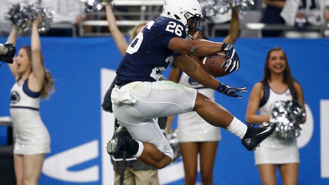 Penn State running back Saquon Barkley (26) scores a 92-yard touchdown run during the first half of the Fiesta Bowl NCAA college football game against Washington, Saturday, Dec. 30, 2017, in Glendale, Ariz. (AP Photo/Ross D. Franklin) ORG XMIT: AZMY
