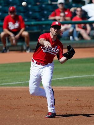 Non-roster invitee infielder Josh Satin throws to first base for an out agains the Cleveland Indians, Thursday, March 5, 2015.