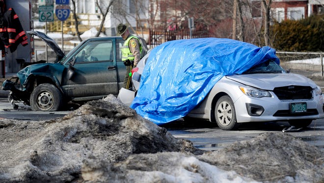 A Vermont State Police crash investigator examines the scene of a double fatal crash between a car and a small truck at the intersection of Berlin Street and Vermont 62 in Barre City on Feb. 22, 2017. One of the two elderly sisters occupying the sedan died on scene. The other sister died from her injuries in the hospital.