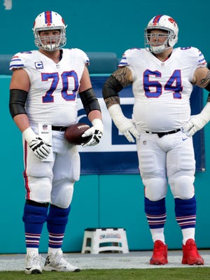 Buffalo Bills center Eric Wood (70) and offensive guard Richie Incognito (64), warm up before during the first half of an NFL football game against the Miami Dolphins.