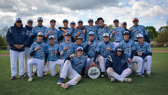 Livonia Stevenson's varsity baseball team happily gathers around the coveted 'City Champs' jug after defeating Livonia Franklin on Saturday.