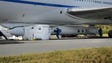 Technicians work on the Pegasus XL rocket slung beneath