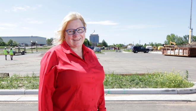 Ann Werth stands at the construction site for the waterfront development in downtown Wausau.