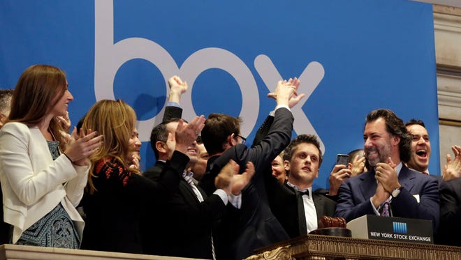 Box CEO and co-founder Aaron Levie, second from right, gets a high-five during opening bell ceremonies to mark the company's IPO at the New York Stock Exchange earlier this year.