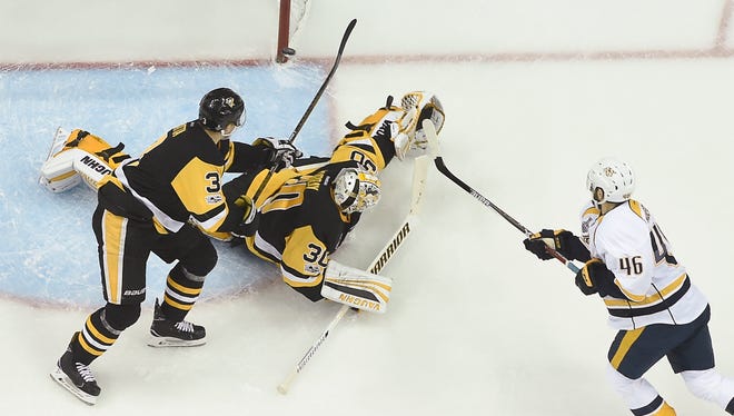 Predators left wing Pontus Aberg (46) shoots the puck past Penguins goalie Matt Murray (30) and defenseman Olli Maatta (3) to score during the first period of Game 2 of the Stanley Cup Final on Wednesday, May 31, 2017.