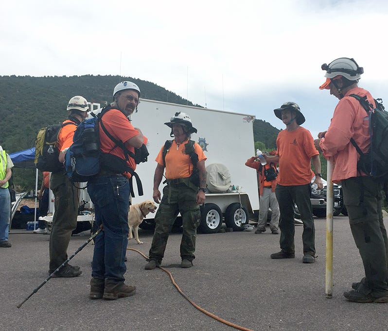 A group of first responders near where a flash flood killed at least nine people in Tonto National Forest.