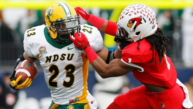 Jan 10, 2015; Frisco, TX, USA;North Dakota State Bison running back John Crockett (23) is face masked by Illinois State Redbirds safety Tevin Allen (1) in the first quarter  of the Division I championship at Pizza Hut Park. Mandatory Credit: Tim Heitman-USA TODAY Sports