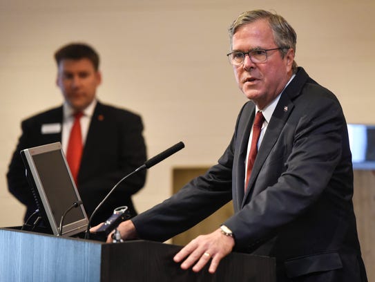 Jeb Bush answers questions during a news conference