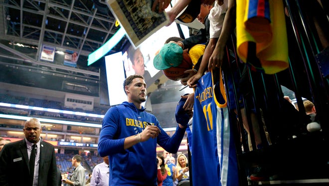 Golden State Warriors guard Klay Thompson (11) signs autographs before the start of a game against the Sacramento Kings at the Golden 1 Center.