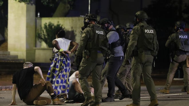 Athens-Clarke County police officers arrest protesters on Broad Street late Sunday, May 31, 2020.