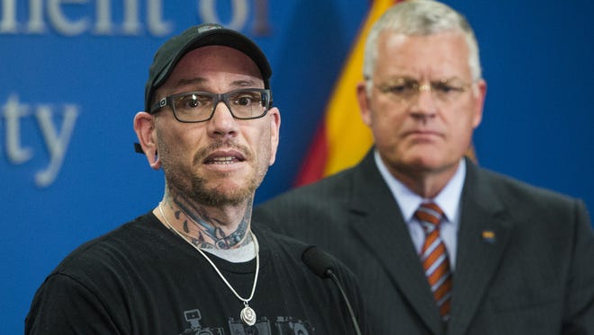 Thomas Yoxall, 43 (left) the Good Samaritan who stopped to help Arizona Public Safety Trooper Ed Andersson and ended up shooting a suspect who was attacking the officer, meets the media for the first time, Tuesday, January 24, 2016, in Phoenix. DPS Director Col. Frank Milstead is at right.