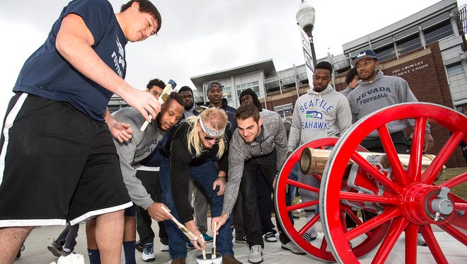 Nevada football team seniors paint Fremont Cannon on campus Sunday