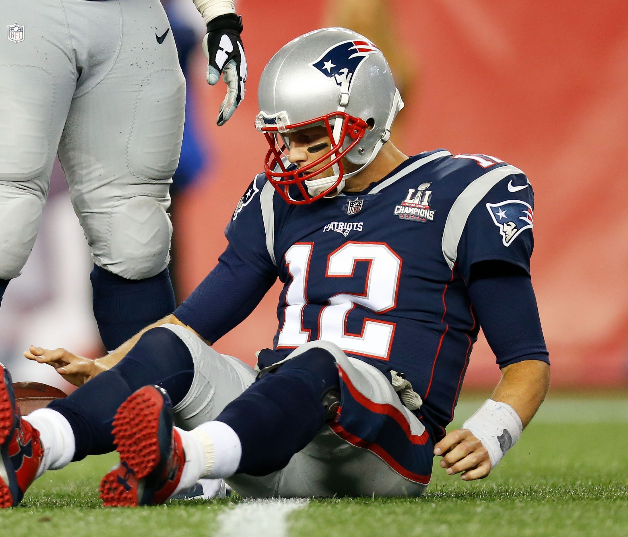New England Patriots quarterback Tom Brady lies on the field after being sacked in the fourth quarter against the Kansas City Chiefs.