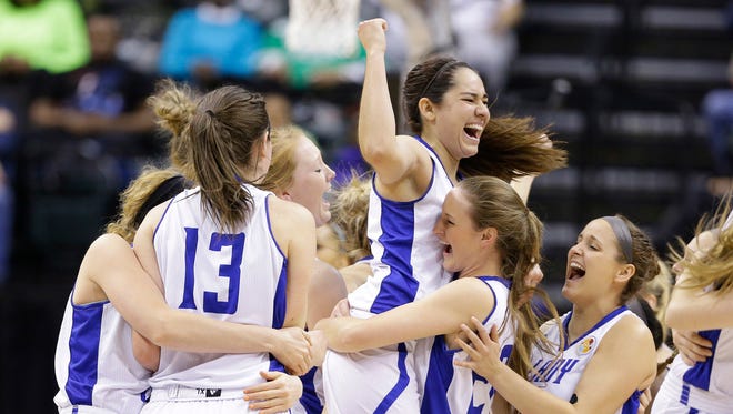 Lubbock Christian's Kelsey Hoppel celebrates with teammates after they defeated Alaska Anchorage to win the championship game at the women's NCAA Division II basketball tournament Monday, April 4, 2016, in Indianapolis.