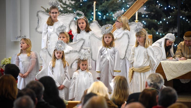 The chorus of angels make their entrance during a Christmas Eve service Thursday afternoon at Bethlehem Lutheran Church in St. Cloud. 