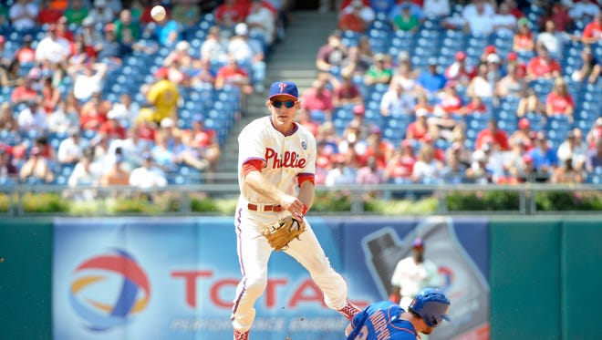 Philadelphia Phillies second baseman Chase Utley (26) avoids the slide of New York Mets second baseman Daniel Murphy (28) as he throws to first base to complete double play Sunday in the fourth inning at Citizens Bank Park. Credit: Eric Hartline-USA TODAY Sports