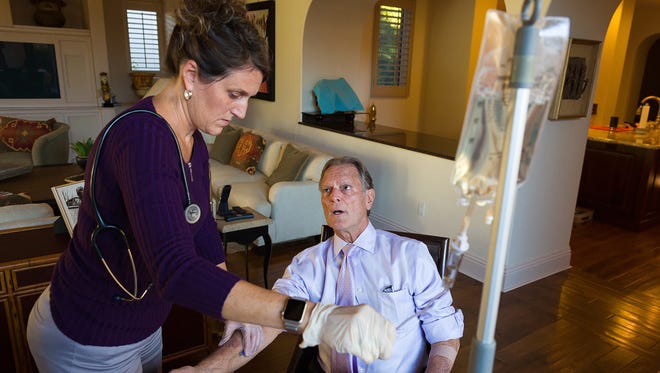 Local immigration attorney Casey Wolff receives a weekly infusion to treat his Alpha-1 antitrypsin deficiency with nurse consultant Nancy McGivern on Tuesday, Nov. 22, 2016, in North Naples. Wolff is working to raise awareness for the genetic condition, which causes lung and possible liver damage which is often misdiagnosed as other lung ailments.