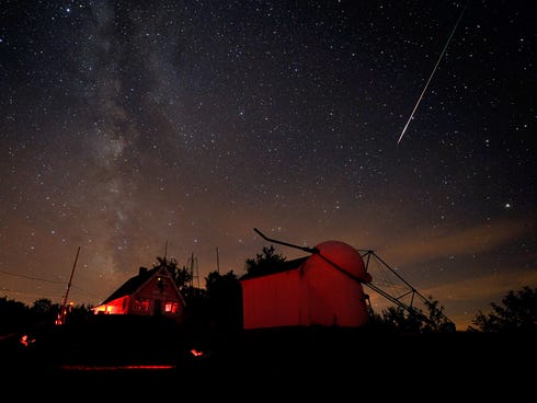 A bright Perseid meteor streaked down Saturday night (Aug. 7, 2010) over buildings at the Stellafane amateur astronomy convention in Springfield, Vermont.