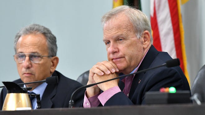 Brevard County Commissioner Curt Smith, at right, sponsored the measure to allow up to $1 million a year in Tourist Development Tax money to be used for Indian River Lagoon projects. Seated next to Smith at Tuesday's County Commission meeting is County Manager Frank Abbate.