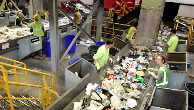 Penn Waste recycling center sorters work along a conveyor Friday, March 25, 2016. Penn Waste is urging customers to contain medical waste, like dirty needles, and dispose of it in their regular trash for the safety of their workers. Bill Kalina photo